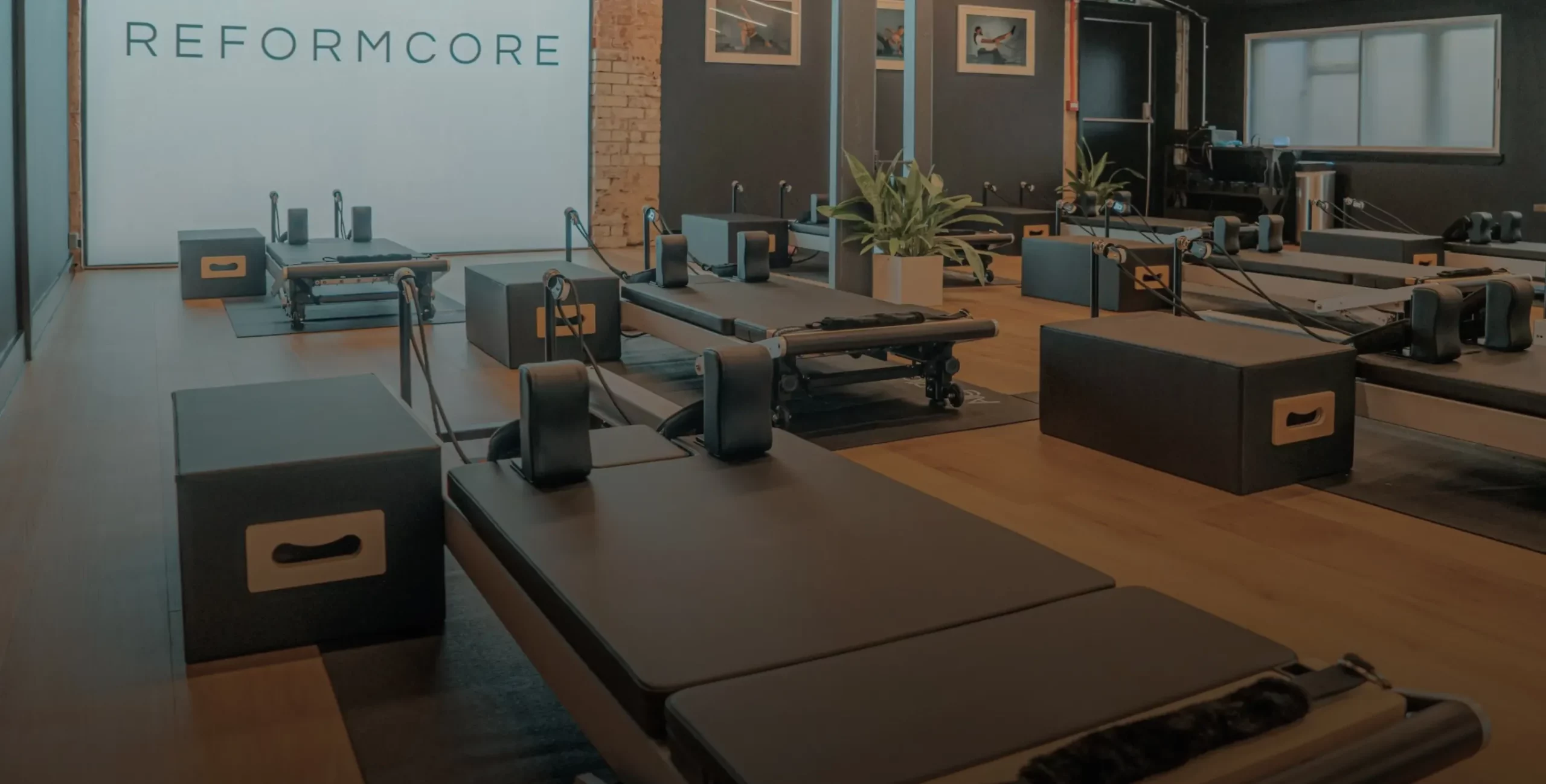 Interior view of the Reformcore studio featuring premium Reformer machines, minimalist design, and a boutique Pilates environment focused on strength, style, and performance.